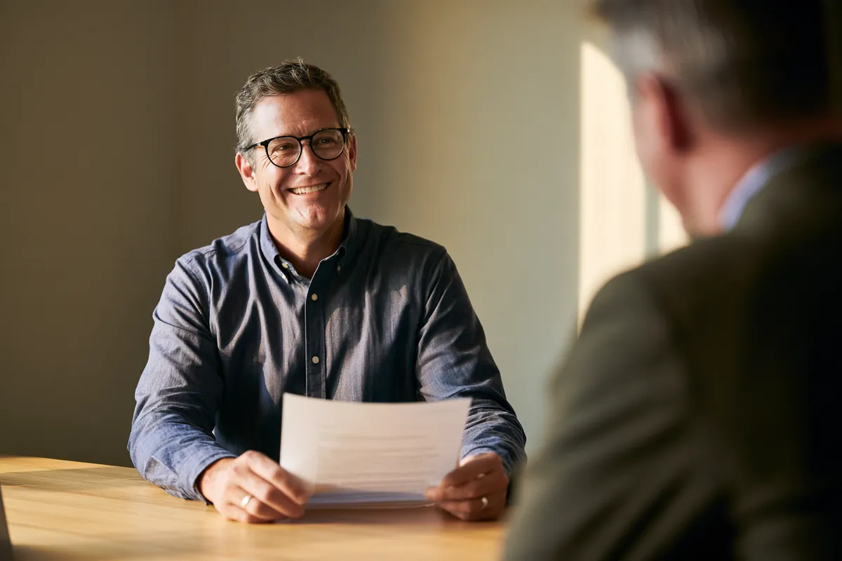 Confident borrower reviewing a simple personal loan agreement with a Donkey Loans network advisor